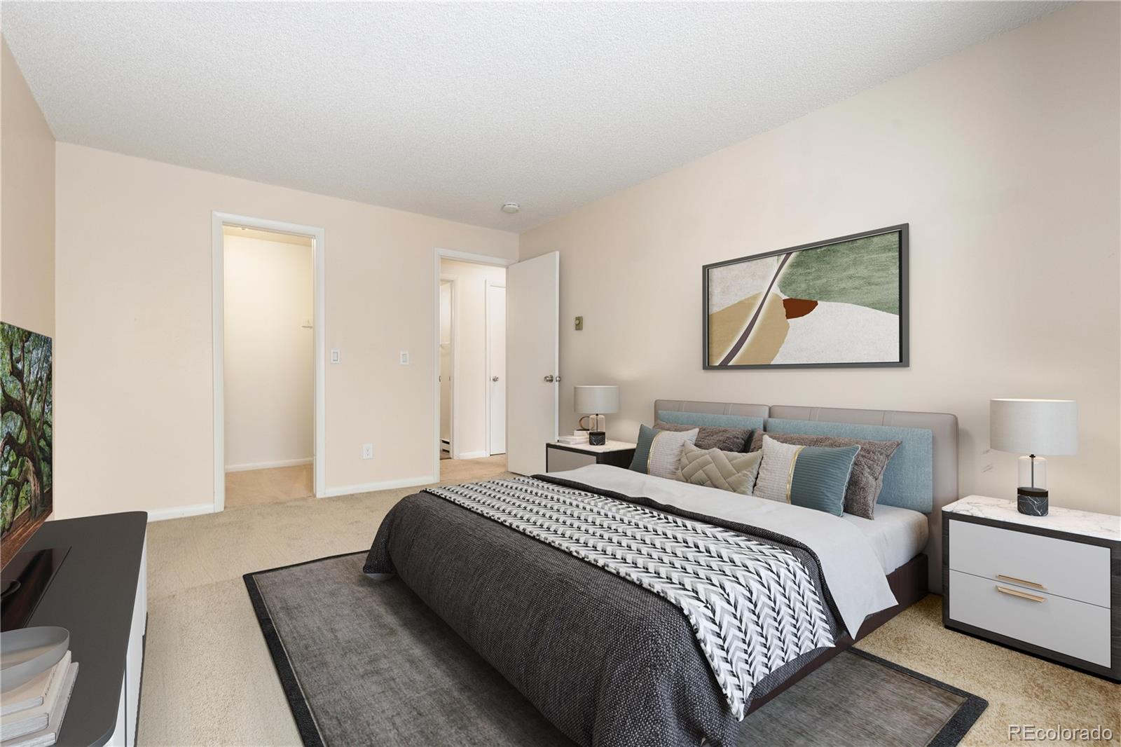 4068 South Atchison Way, Unit 202 Aurora, CO 80014 - Photo 4 of 33 a bedroom with a large bed and a couch