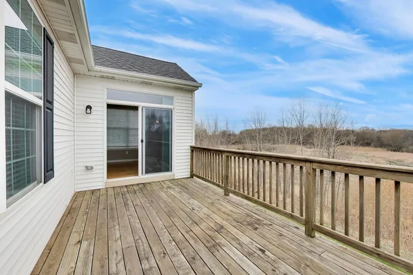 a view of a wooden deck with a yard