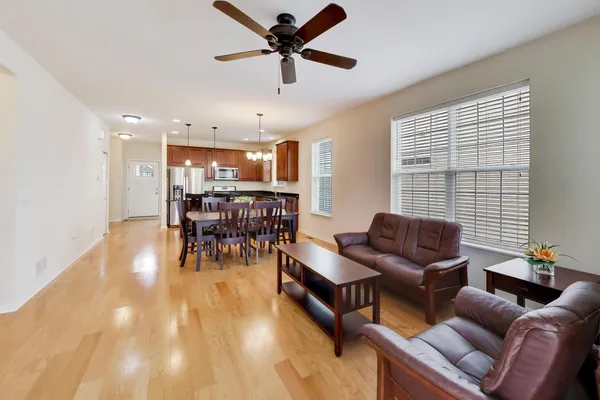 a living room with furniture and kitchen view