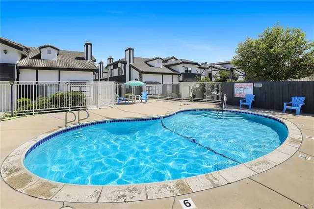 a view of a house with roof deck and seating space