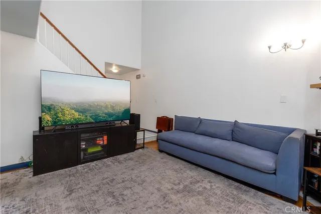 a living room with furniture and a floor to ceiling window