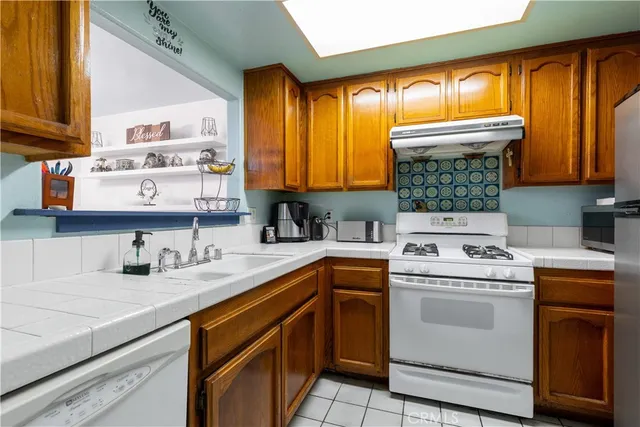 a kitchen with a sink stove and cabinets