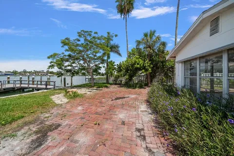 a view of a big room with windows and chandelier fan