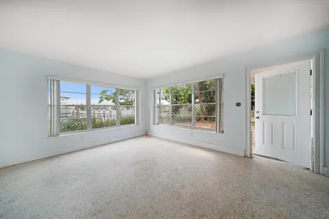 a view of a glass door with a tree in front of it