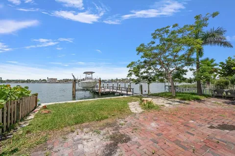 a roof deck with table and chairs a barbeque with wooden floor and city view