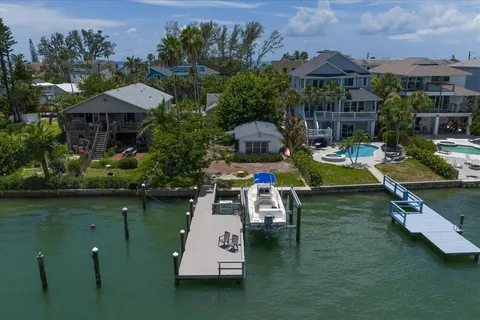 an aerial view of a house with swimming pool garden view and a lake view