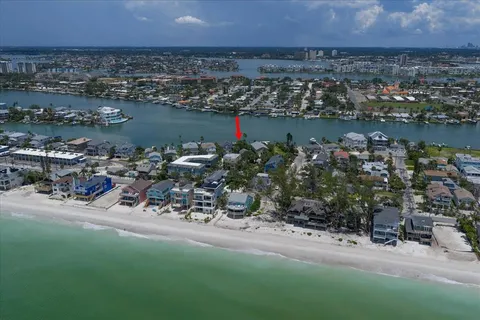 an aerial view of a house with a yard and lake view