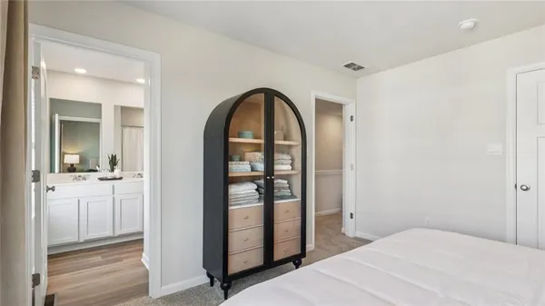 a bedroom with a bed and a mirror