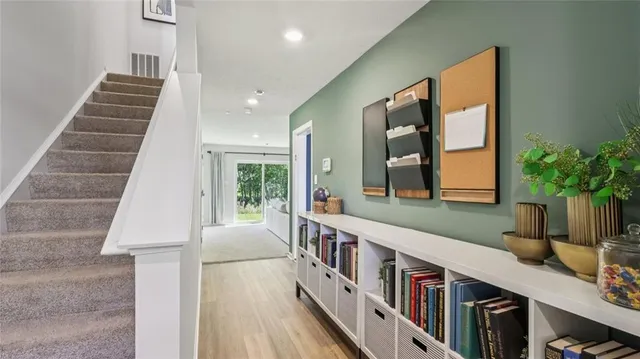 a view of an entryway wooden floor and a front door