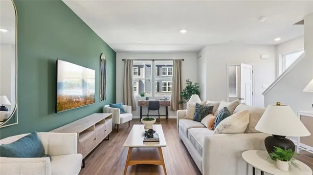 a living room with furniture large window and flat screen tv