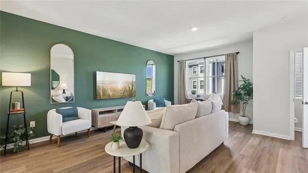 a living room with furniture and wooden floor