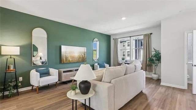 a living room with furniture and wooden floor