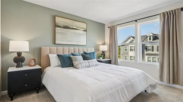 a bedroom with a large bed and a window