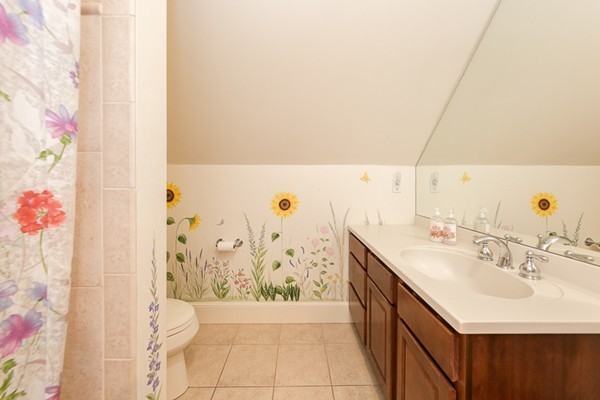 82 Middle Street Lexington, MA 02421 - Photo 20 of 27 a bathroom with a sink a toilet and shower curtain