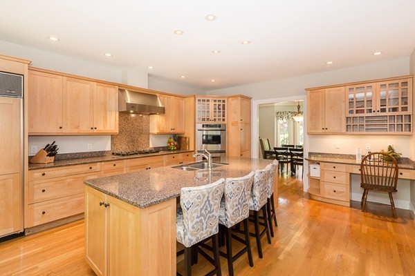 82 Middle Street Lexington, MA 02421 - Photo 6 of 27 a kitchen with granite countertop a stove a sink a dining table and chairs