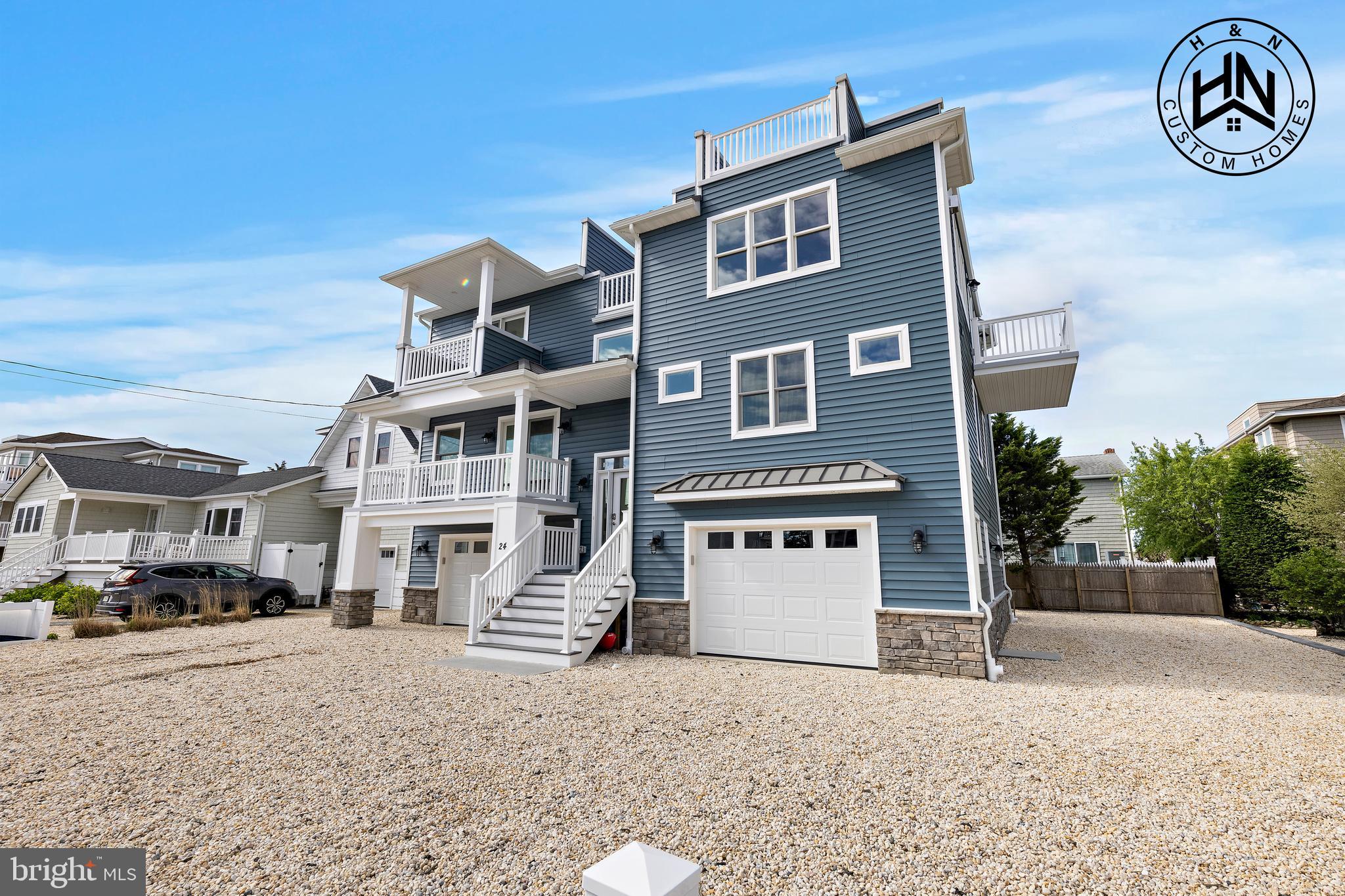 24 West 53rd Street Long Beach Township, NJ 08008 - Photo 16 of 75 a front view of a building with a yard