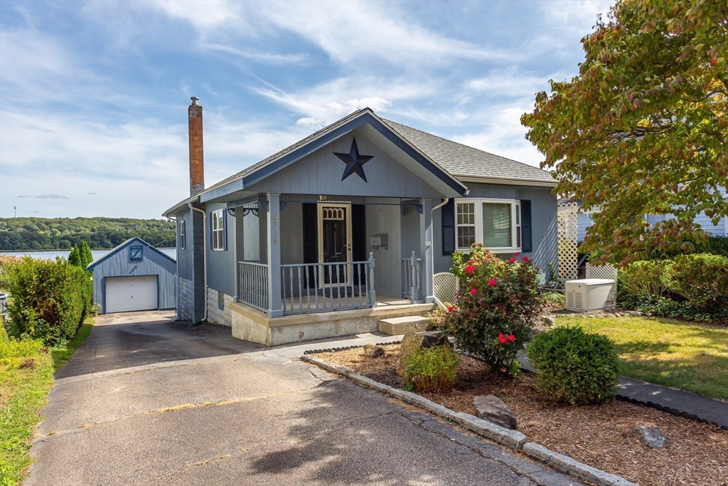 a front view of house with yard and green space