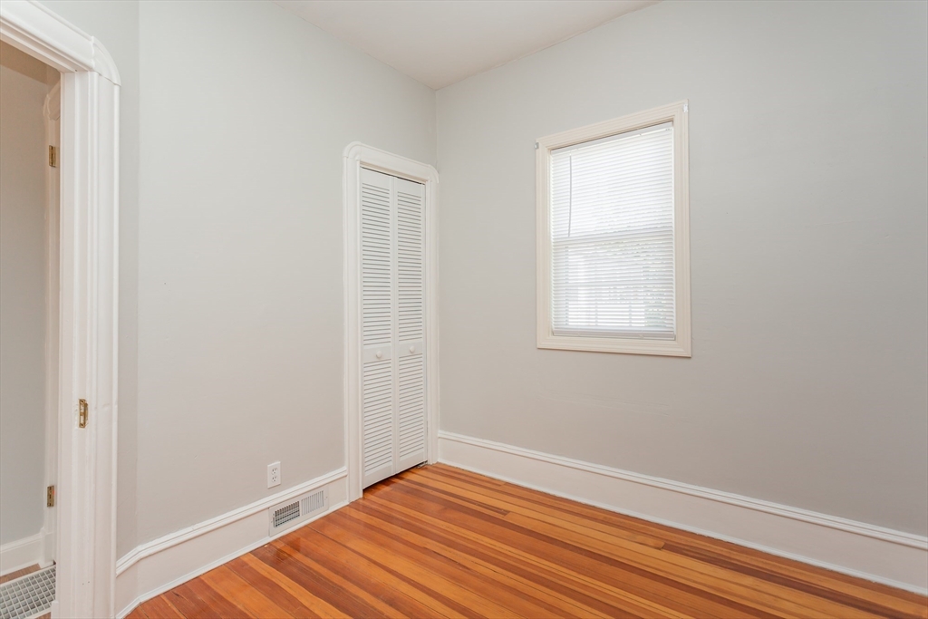 2714 Riverside Avenue Somerset, MA 02726 - Photo 16 of 36 a view of an empty room with wooden floor and a window
