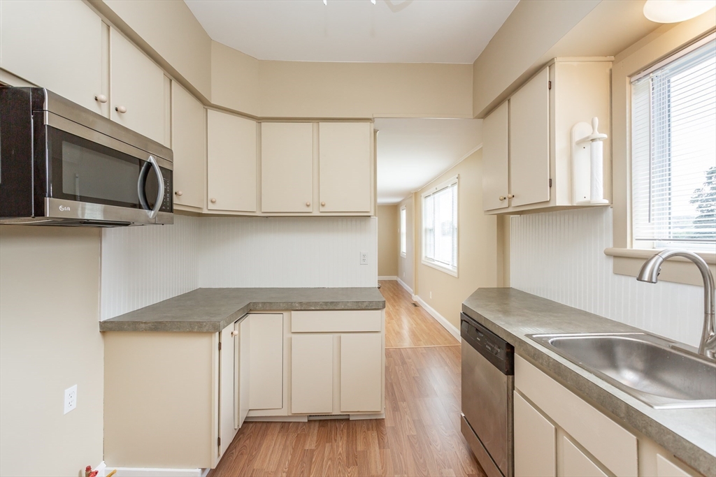 2714 Riverside Avenue Somerset, MA 02726 - Photo 21 of 36 a kitchen with stainless steel appliances granite countertop white cabinets a sink and dishwasher
