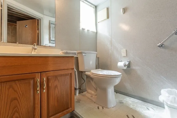 a bathroom with a sink toilet and mirror