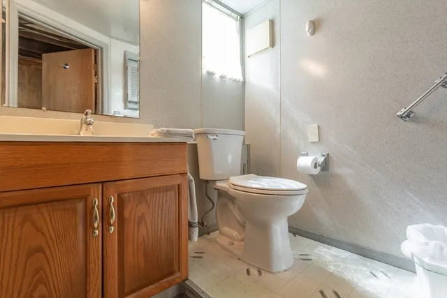 a bathroom with a sink toilet and mirror