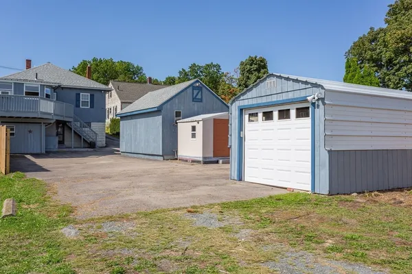 a view of a house with a yard and garage