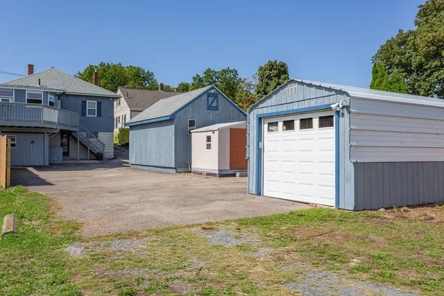 a view of a house with a yard and garage