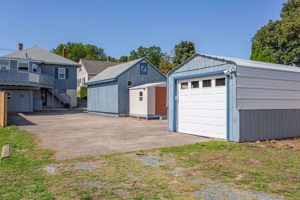 2714 Riverside Avenue Somerset, MA 02726 - Photo 32 of 36 a view of a house with a yard and garage