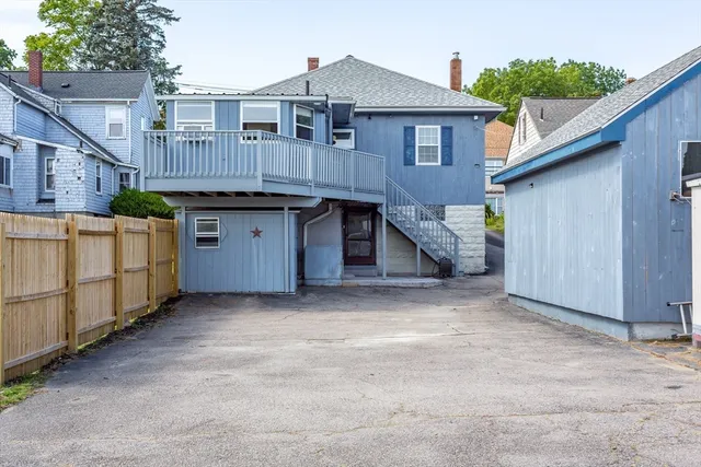 a view of a house with a wooden fence and a stairs