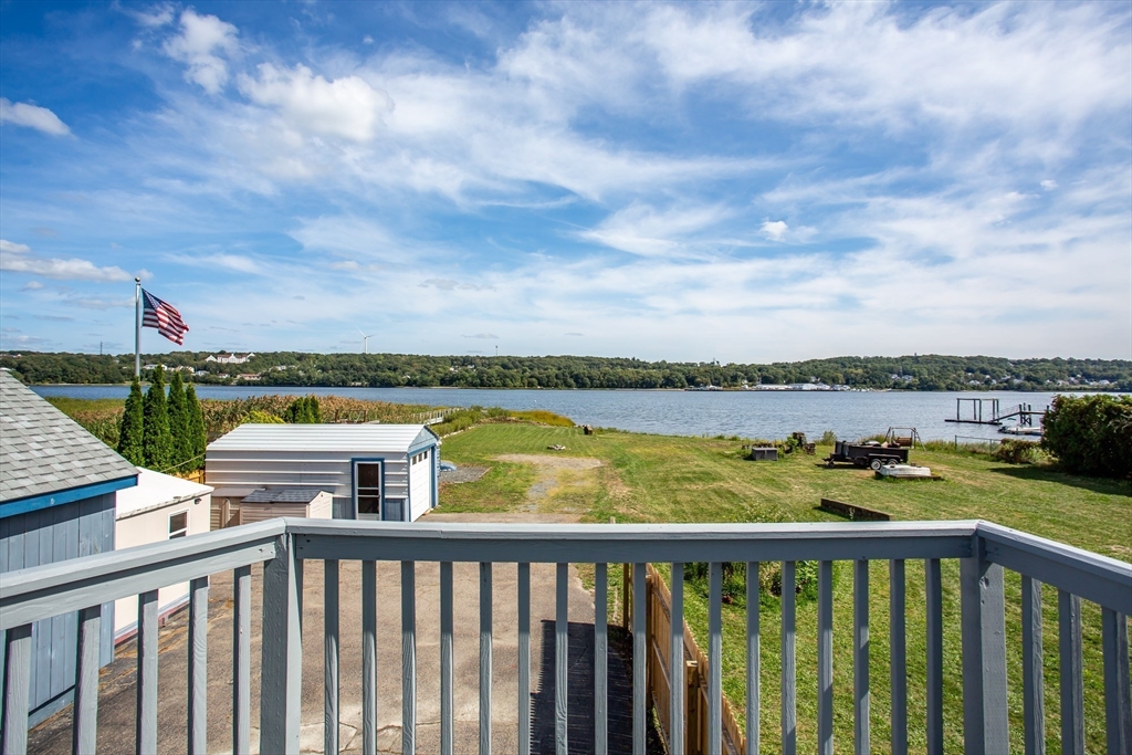 2714 Riverside Avenue Somerset, MA 02726 - Photo 5 of 36 a view of a balcony with wooden floor & fence
