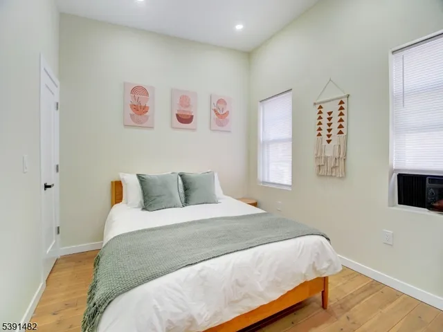 a bedroom with a bed and a painting on the wall