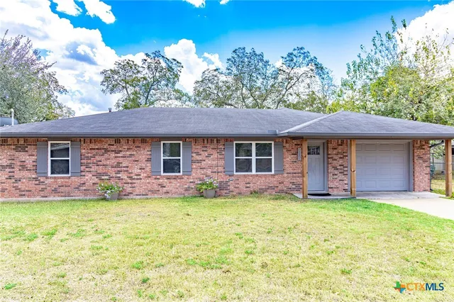 front view of a house with a yard