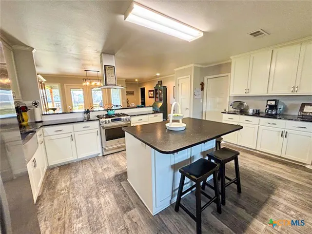 a kitchen with a sink a counter top space and stainless steel appliances