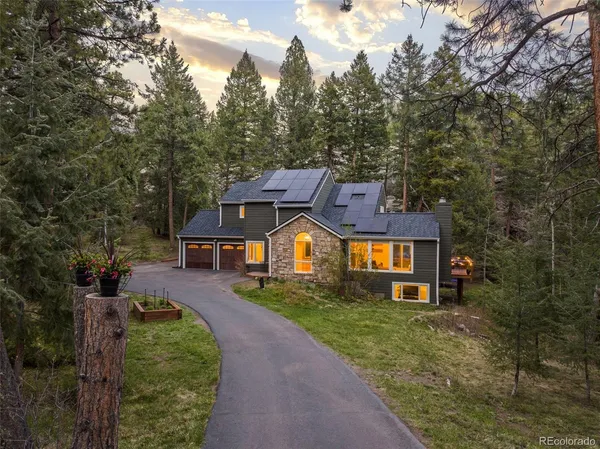 a front view of a house with a yard and trees