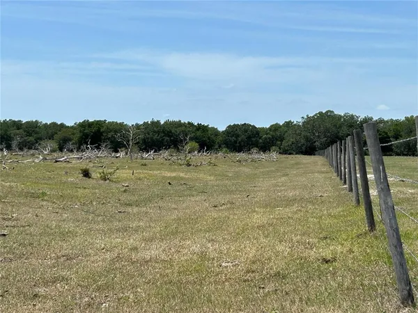 a view of a field with wooden fence