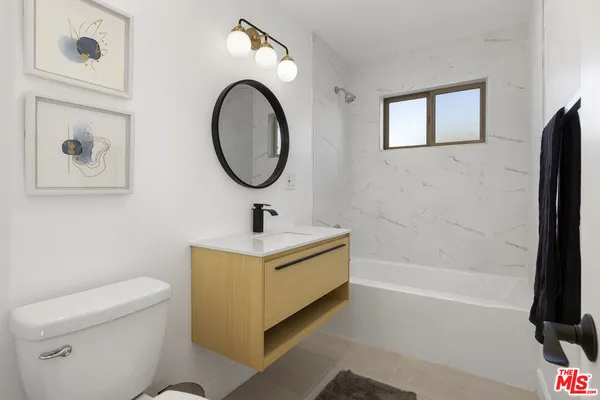 a bathroom with a sink a toilet and a bathtub