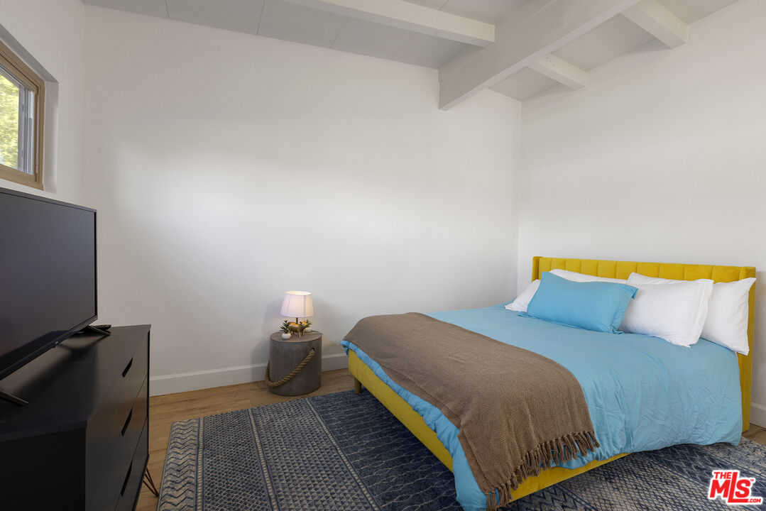 Undisclosed Address Palm Desert, CA 92260 - Photo 14 of 24 a bedroom with a bed and a flat tv screen on a dresser