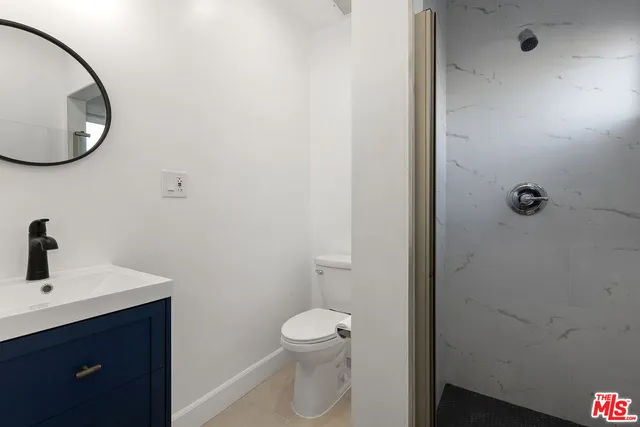 a bathroom with a toilet a sink and a mirror