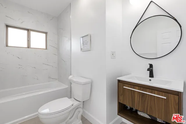 a bathroom with a toilet a sink and bathtub