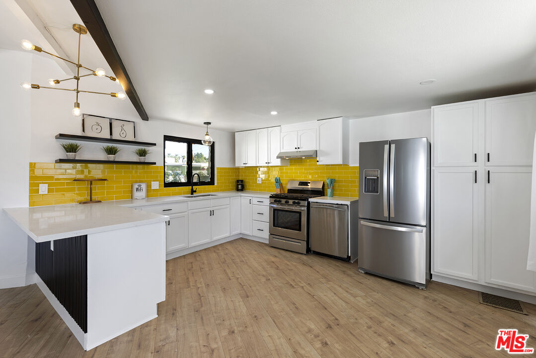 Undisclosed Address Palm Desert, CA 92260 - Photo 10 of 24 a kitchen with stainless steel appliances granite countertop a refrigerator a stove top oven a sink and dishwasher