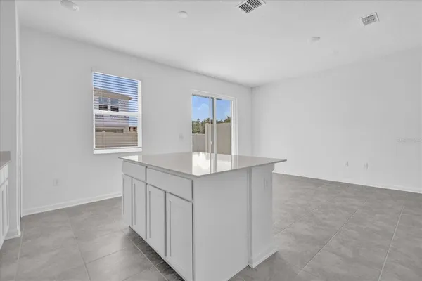 a kitchen with kitchen island cabinets and window
