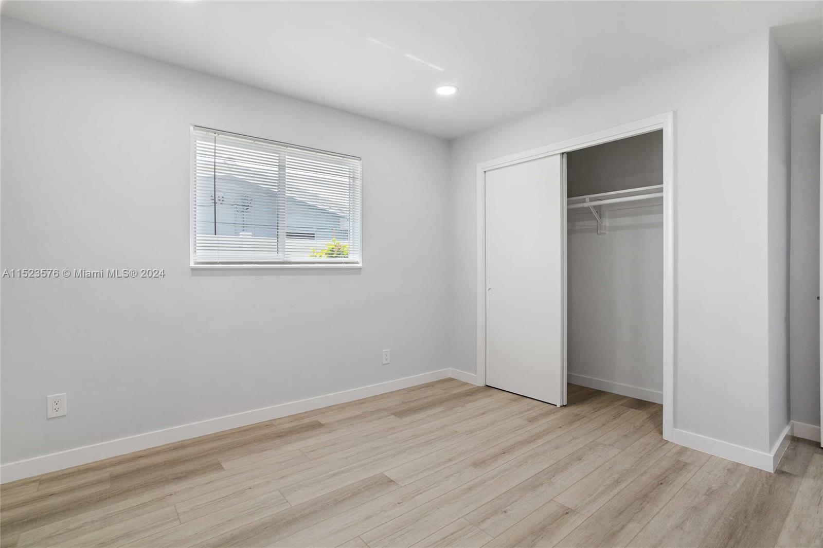 3329 Arthur Street Hollywood, FL 33021 - Photo 13 of 25 an empty room with wooden floor and windows