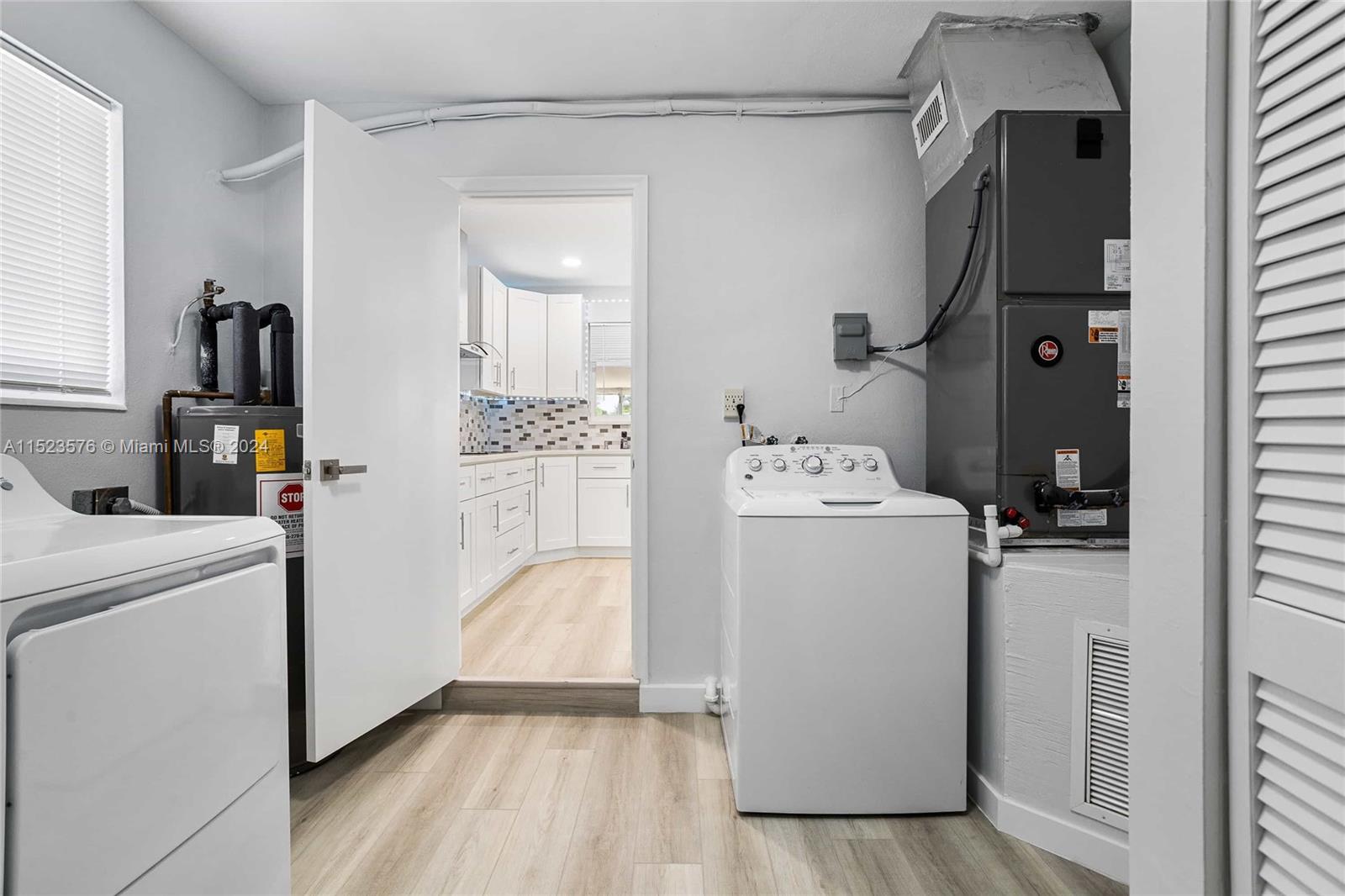 3329 Arthur Street Hollywood, FL 33021 - Photo 17 of 25 a utility room with cabinets washer and dryer