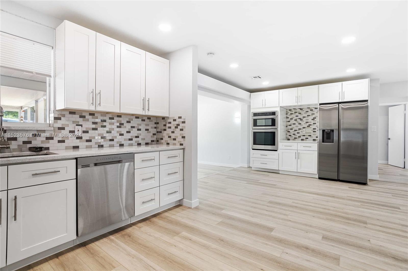 3329 Arthur Street Hollywood, FL 33021 - Photo 7 of 25 a kitchen with stainless steel appliances a refrigerator sink and cabinets