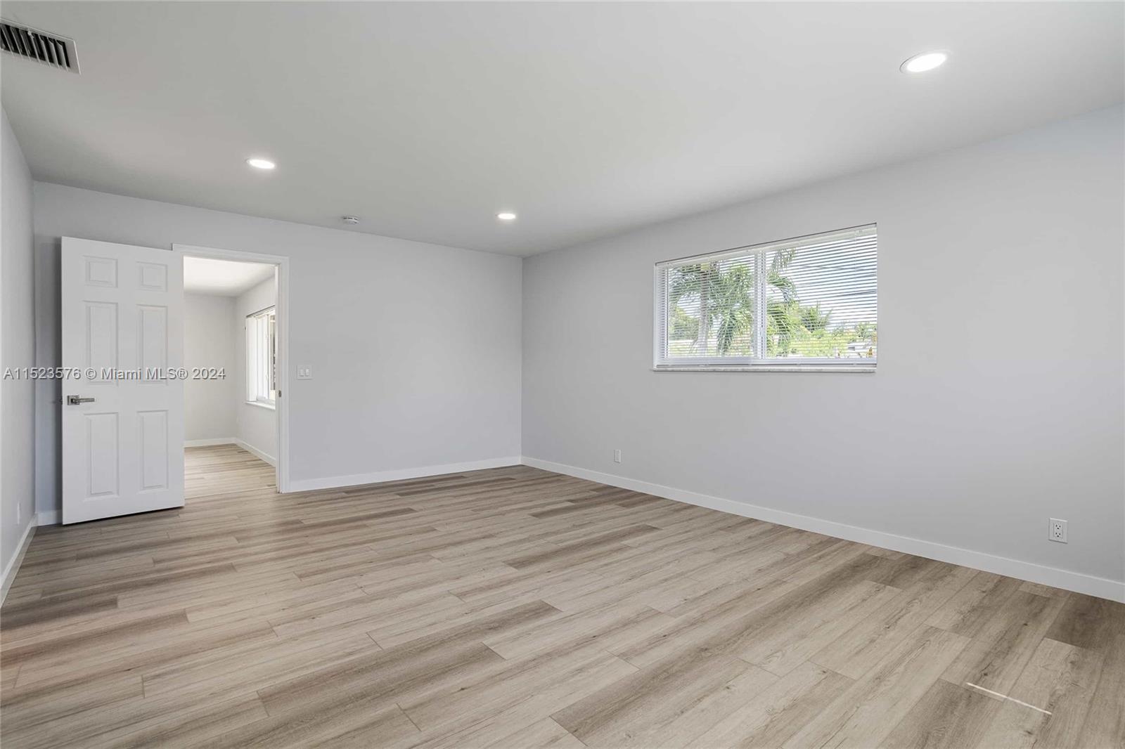 3329 Arthur Street Hollywood, FL 33021 - Photo 8 of 25 an empty room with wooden floor and windows