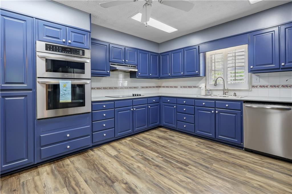 4012 Morris Road Powder Springs, GA 30127 - Photo 11 of 64 a kitchen with stainless steel appliances granite countertop a stove microwave and cabinets