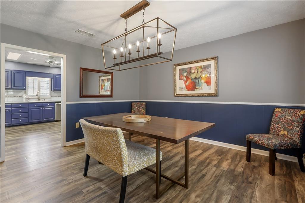 4012 Morris Road Powder Springs, GA 30127 - Photo 14 of 64 a view of a dining room with furniture and wooden floor
