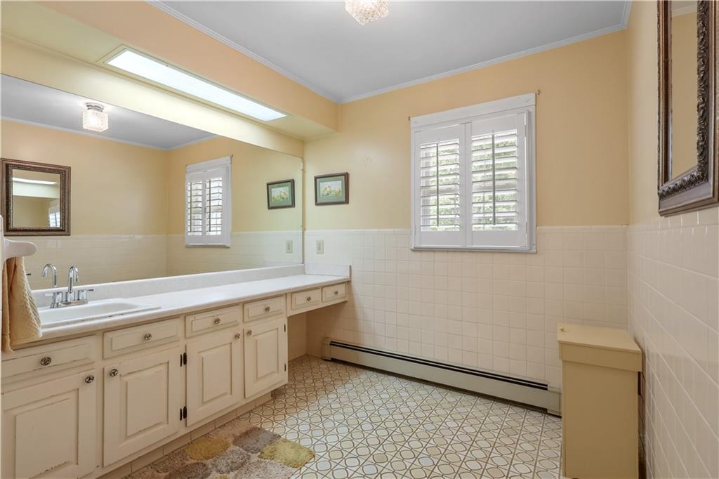 4012 Morris Road Powder Springs, GA 30127 - Photo 25 of 64 a spacious bathroom with a granite countertop sink a toilet and a mirror