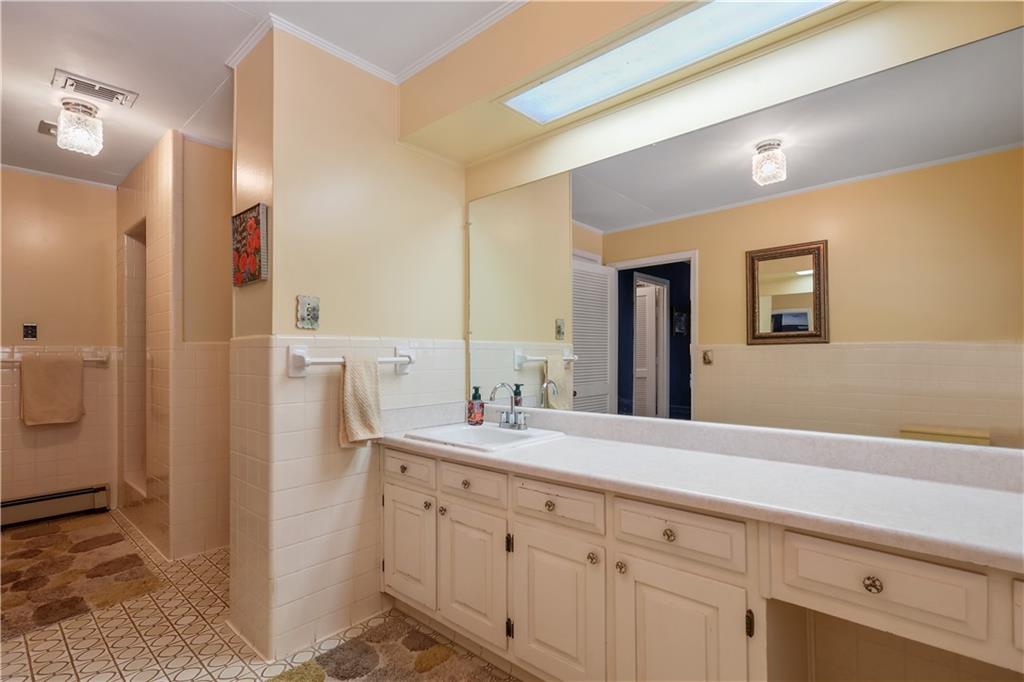 4012 Morris Road Powder Springs, GA 30127 - Photo 26 of 64 a bathroom with a double vanity sink mirror and shower