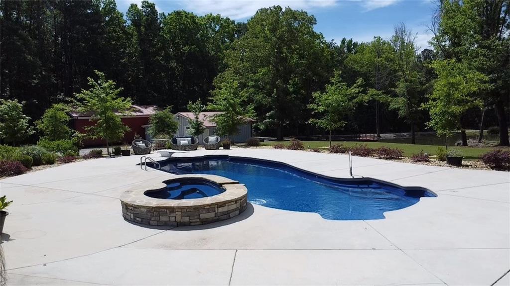 4012 Morris Road Powder Springs, GA 30127 - Photo 41 of 64 a view of a swimming pool with a yard